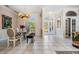 Light-filled dining room boasts elegant chandelier, neutral walls, and tile flooring at 394 Tall Oak Trl, Tarpon Springs, FL 34688