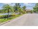 Community entrance featuring lush tropical landscaping, a fountain, and a gated entry at 394 Tall Oak Trl, Tarpon Springs, FL 34688