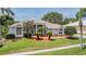 Charming home with lush front lawn, mature landscaping, and manicured garden beds at 394 Tall Oak Trl, Tarpon Springs, FL 34688