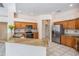 Eat-in kitchen featuring granite countertops, stainless steel appliances, tile floors, and wood cabinetry at 394 Tall Oak Trl, Tarpon Springs, FL 34688