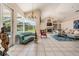 Bright sunroom with vaulted ceilings and views of the backyard at 394 Tall Oak Trl, Tarpon Springs, FL 34688