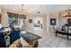 Spacious living area with multiple entryways, elegant furniture, and tile flooring at 394 Tall Oak Trl, Tarpon Springs, FL 34688