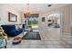 Elegant living room with decorative chandelier, tile floors, and outdoor view at 394 Tall Oak Trl, Tarpon Springs, FL 34688