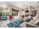 Well-lit living room with fireplace, chandelier, tile flooring, and access to screened lanai at 394 Tall Oak Trl, Tarpon Springs, FL 34688