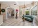 Bright living room featuring tile floors, high ceilings, art, and comfortable seating at 394 Tall Oak Trl, Tarpon Springs, FL 34688
