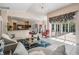 Inviting living room featuring open floorplan, tile floors, chandelier, and views of screened lanai at 394 Tall Oak Trl, Tarpon Springs, FL 34688