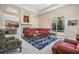Spacious living room showcasing a fireplace, large window, and access to the outdoor pool area at 394 Tall Oak Trl, Tarpon Springs, FL 34688