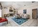 Spacious living room with fireplace, chandelier, tile flooring, and bright, natural light at 394 Tall Oak Trl, Tarpon Springs, FL 34688