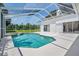 Sparkling pool enclosed within a screened lanai, offering a refreshing escape with privacy and shade at 394 Tall Oak Trl, Tarpon Springs, FL 34688