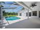 Inviting screened pool area provides a private retreat, set against a backdrop of mature trees at 394 Tall Oak Trl, Tarpon Springs, FL 34688