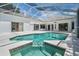 Gorgeous screened pool with a jacuzzi, tile surround, and ample deck space for entertaining and relaxing at 394 Tall Oak Trl, Tarpon Springs, FL 34688