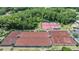 Aerial shot featuring several meticulously maintained tennis courts surrounded by lush greenery at 394 Tall Oak Trl, Tarpon Springs, FL 34688