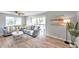 Bright living room with light gray walls, wood-look floors, and a sliding glass door to the outside at 6311 Newtown Cir # 11B1, Tampa, FL 33615