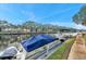 Picturesque water view with covered boats, palm trees, and surrounding condominium buildings at 6311 Newtown Cir # 11B1, Tampa, FL 33615