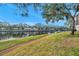 Beautiful water view with manicured lawn, mature trees, and multiple condominium buildings at 6311 Newtown Cir # 11B1, Tampa, FL 33615