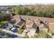 Aerial view showcases the community and surrounding mature trees and landscaping at 8907 Casablanca Way, Tampa, FL 33626
