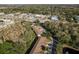 A bird's eye view of townhomes in a commercial area with lush landscaping, showcasing the convenient location at 8907 Casablanca Way, Tampa, FL 33626