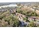 Aerial shot showcases a community with townhomes, a tranquil lake, and scenic surroundings at 8907 Casablanca Way, Tampa, FL 33626