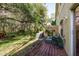 Relaxing back deck with a comfortable seating area and a lush green backyard at 8907 Casablanca Way, Tampa, FL 33626