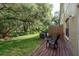 Relax in this peaceful backyard with mature trees and a wood deck with seating at 8907 Casablanca Way, Tampa, FL 33626