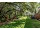 Picturesque backyard featuring a manicured lawn, mature trees, and a peaceful atmosphere at 8907 Casablanca Way, Tampa, FL 33626
