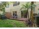 Enjoy this backyard space featuring a lush green yard, palms, and a patio area at 8907 Casablanca Way, Tampa, FL 33626