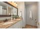 Bathroom featuring double sinks, granite counters, and ample vanity storage space at 8907 Casablanca Way, Tampa, FL 33626