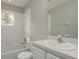 Bathroom with white vanity and shower over tub and a window providing natural light at 8907 Casablanca Way, Tampa, FL 33626
