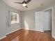 Bedroom with hardwood floors and a ceiling fan with natural light coming from the window at 8907 Casablanca Way, Tampa, FL 33626
