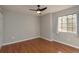 Bedroom with hardwood floors, a ceiling fan and a window providing natural light at 8907 Casablanca Way, Tampa, FL 33626
