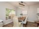 Bright dining area featuring a wooden table, comfortable chairs, and a view of the backyard at 8907 Casablanca Way, Tampa, FL 33626