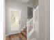 Stylish entry featuring a decorative glass door, wood-look flooring, and a staircase with white railings at 8907 Casablanca Way, Tampa, FL 33626