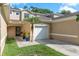 Well-kept townhouse featuring a single-car garage, tasteful neutral stucco, and lush green lawn at 8907 Casablanca Way, Tampa, FL 33626