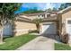 Attractive townhouse with an attached single-car garage, neutral stucco, and well manicured yard at 8907 Casablanca Way, Tampa, FL 33626