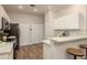 Bright kitchen featuring white cabinets, stainless steel appliances, and modern countertops at 8907 Casablanca Way, Tampa, FL 33626
