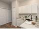 Charming kitchen with white cabinets, modern countertops, and ample storage at 8907 Casablanca Way, Tampa, FL 33626