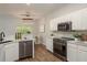 Modern kitchen with stainless steel appliances, white cabinets and eat-in dining area at 8907 Casablanca Way, Tampa, FL 33626