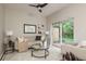 Comfortable living room with a modern sofa, stylish decor, and sliding glass doors to the backyard at 8907 Casablanca Way, Tampa, FL 33626