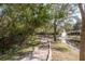 Scenic view of a community pond with a fountain, walking path, and mature trees at 8907 Casablanca Way, Tampa, FL 33626