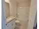 Bathroom featuring a sink with a granite countertop, white cabinets, toilet, and a shower-tub combo at 13290 Ogden Glade Rd, Dade City, FL 33525