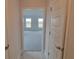Hallway featuring neutral paint and tile floors leading to the living room and bedroom areas at 13290 Ogden Glade Rd, Dade City, FL 33525