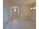 Hallway with tile floors leading to the front door and other rooms at 13290 Ogden Glade Rd, Dade City, FL 33525