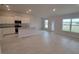 Open-concept kitchen featuring granite countertops, island, and white cabinets at 13290 Ogden Glade Rd, Dade City, FL 33525