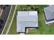 Aerial view of the home showcasing the roof and surrounding landscaping at 1613 Heather Pl, Palm Harbor, FL 34684
