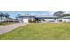 Charming one-story home with a well-maintained lawn and a single-car garage at 1613 Heather Pl, Palm Harbor, FL 34684