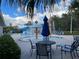 Community pool with water features, seating area, and a slide in the background at 18116 Portside St, Tampa, FL 33647