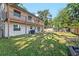 Large backyard featuring a full-length balcony and a well-manicured lawn at 4822 W San Miguel St, Tampa, FL 33629