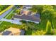 Aerial view of a home showcasing the pool, expansive backyard, and surrounding neighborhood at 6020 Kestrel Point Ave, Lithia, FL 33547