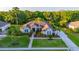 Spacious home with lush landscaping, a long driveway, and mature trees offers curb appeal at 6020 Kestrel Point Ave, Lithia, FL 33547