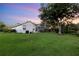 Lush backyard with expansive lawn leading to the home and screened-in porch at 6020 Kestrel Point Ave, Lithia, FL 33547